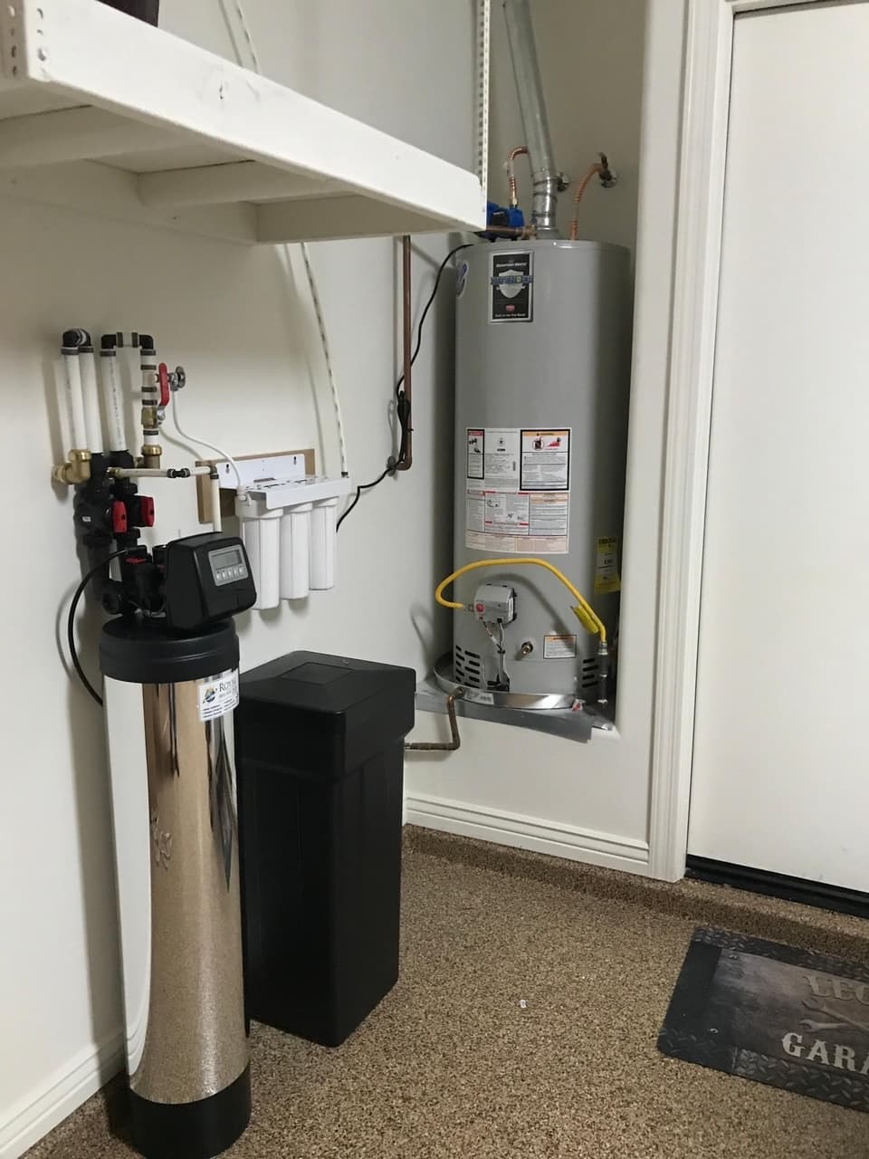 Water softener and filtration equipment installation beside a water heater